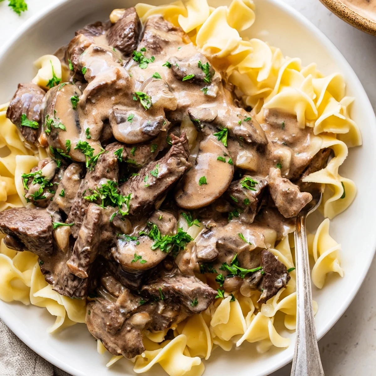 Satisfying Easy Beef Stroganoff garnished with parsley, ideal for a cozy meal.