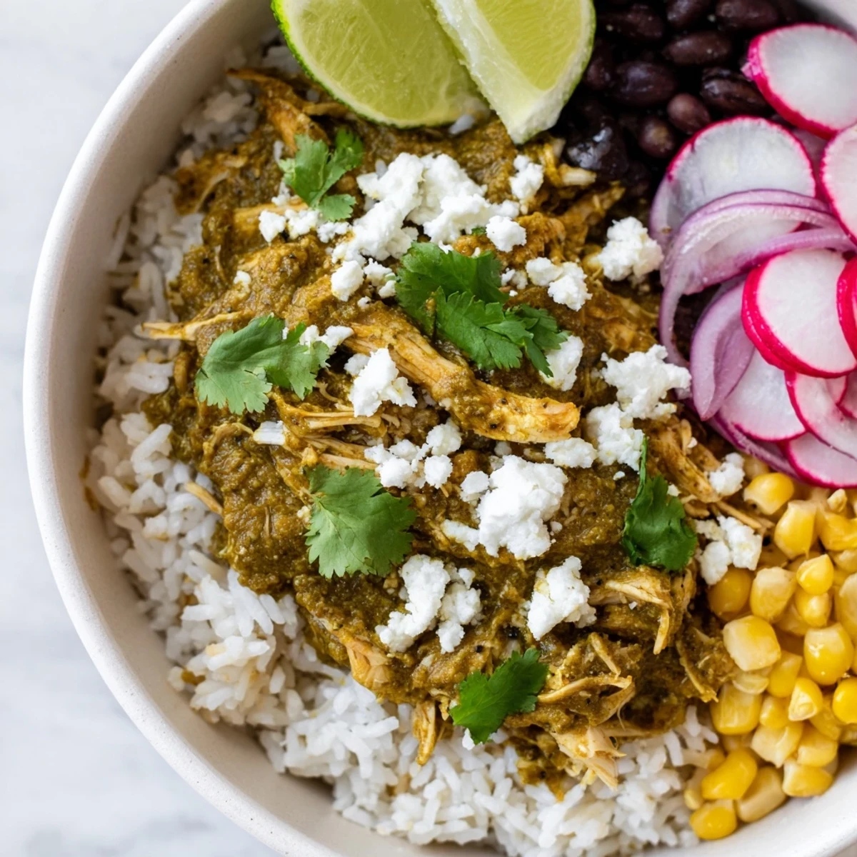 A delicious view of a Green Enchiladas Rice Bowl, with fresh cilantro and creamy avocado slices.
