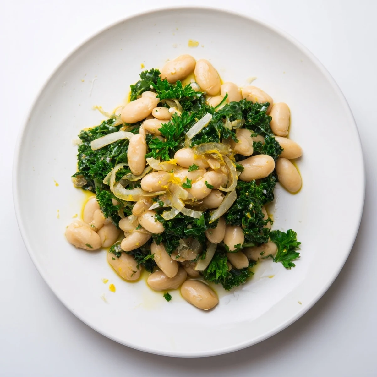 This bowl of garlicky beans with winter greens showcases a comforting, rustic dish on a wooden table.