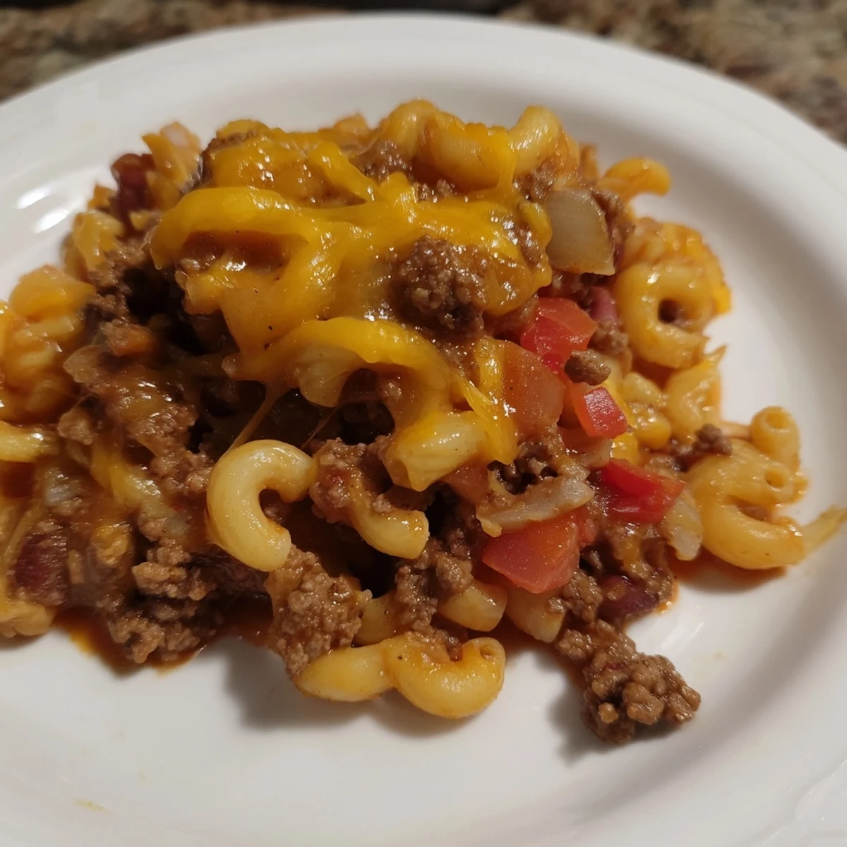 Close-up of a bubbling Cheeseburger Chili Mac Skillet, showcasing the melted cheese and hearty ingredients.