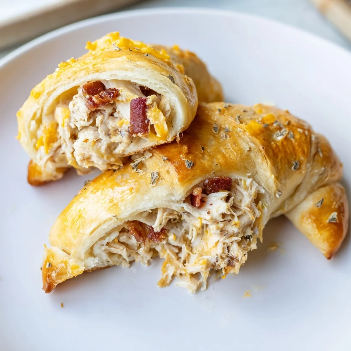 Golden-brown Cheesy Chicken and Bacon Crescent Rolls, filled with melty cheese and crispy bacon.