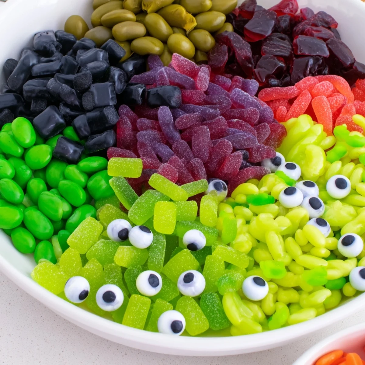 A delicious close-up of the Poison Apple Candy Platter, a spooky mix of apple and berry treats.