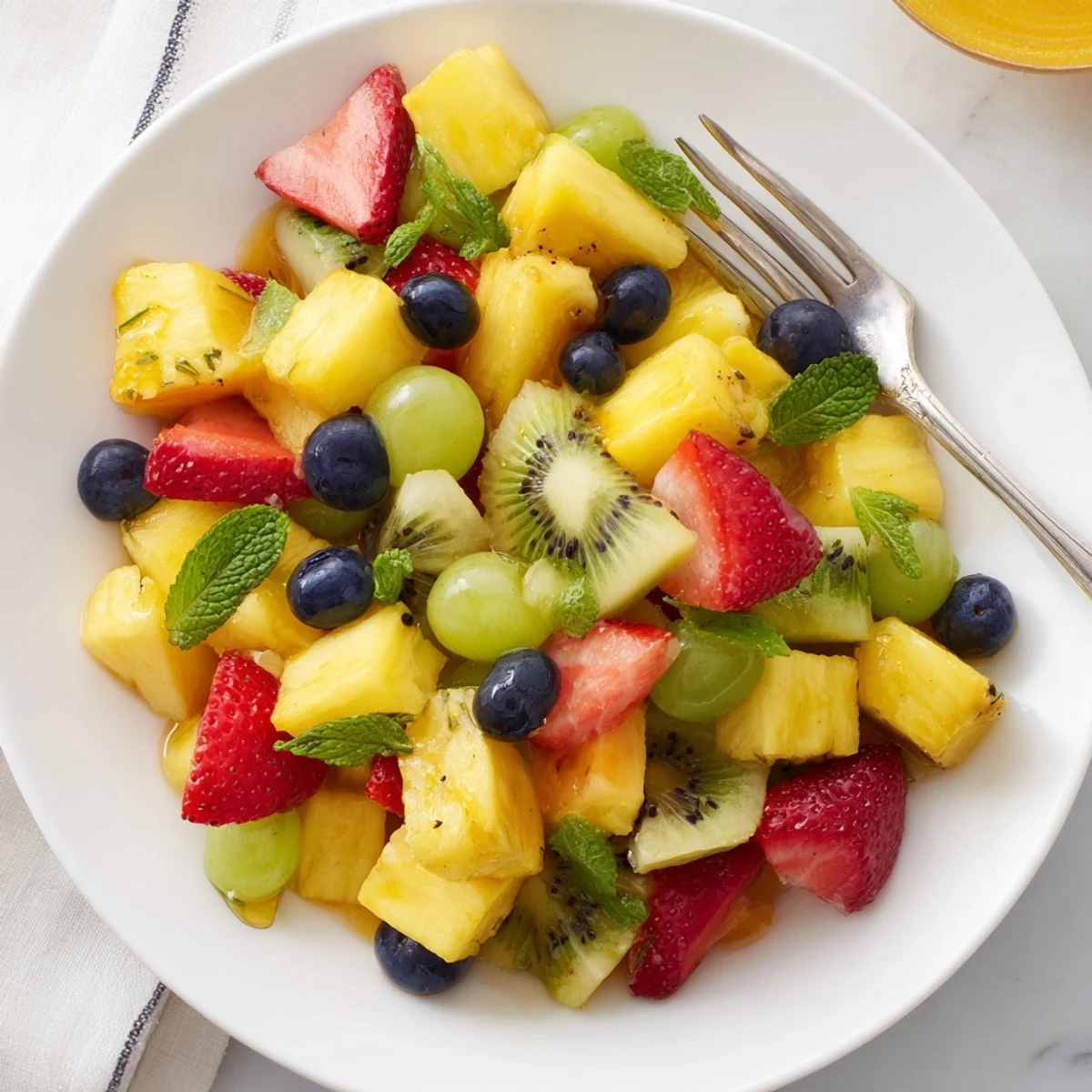 Vibrant Tropical Pineapple Fruit Boat brimming with colorful fruit for a refreshing dessert.