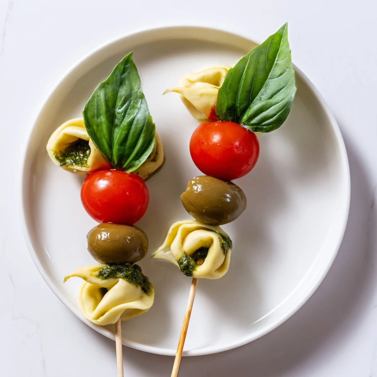 Enjoy these easy Appetizer Skewers, a medley of tortellini, olives, and pesto perfect for entertaining guests.