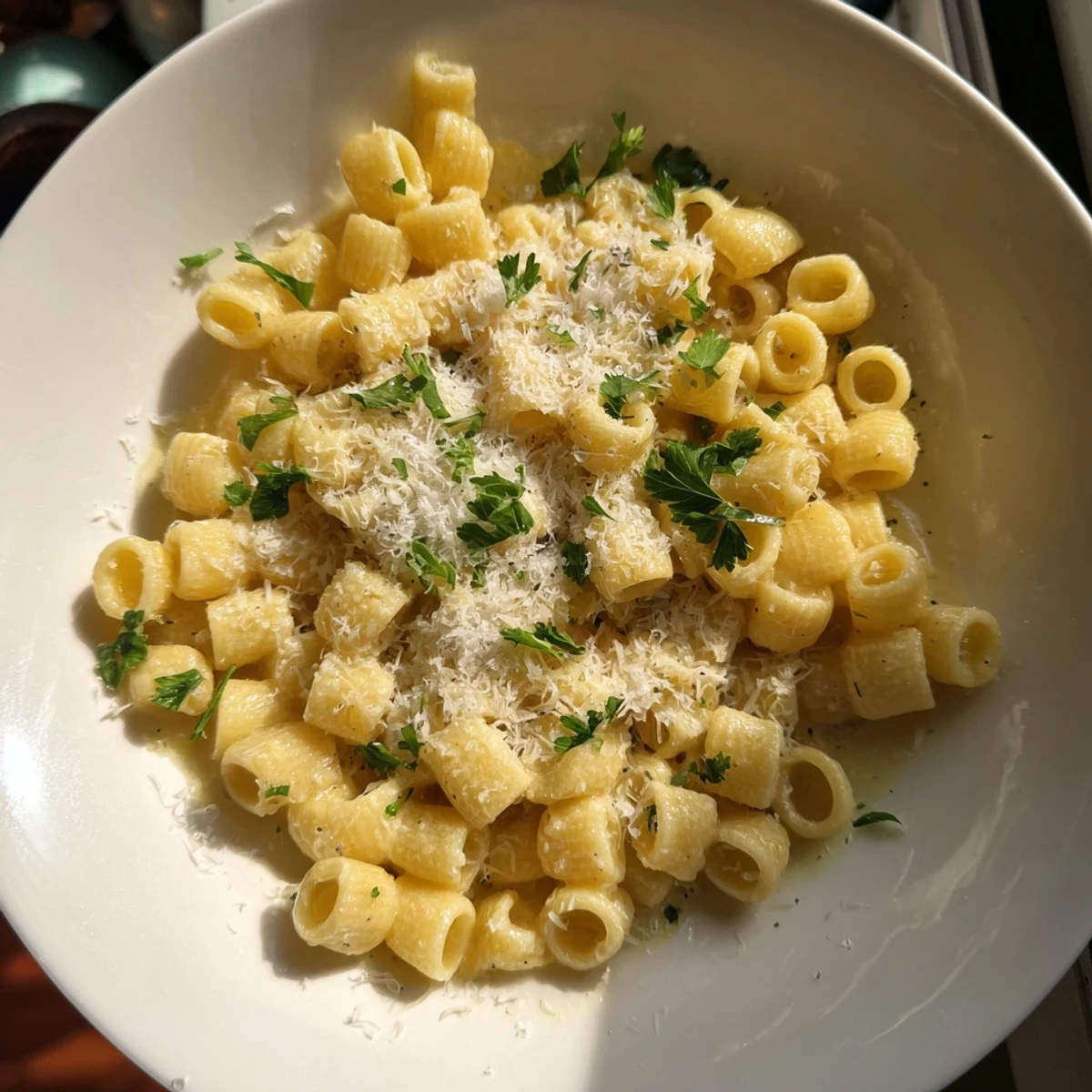 A decadent serving of 15-Minute Garlic Parmesan Pasta, ready to devour with a generous sprinkle of extra cheese.