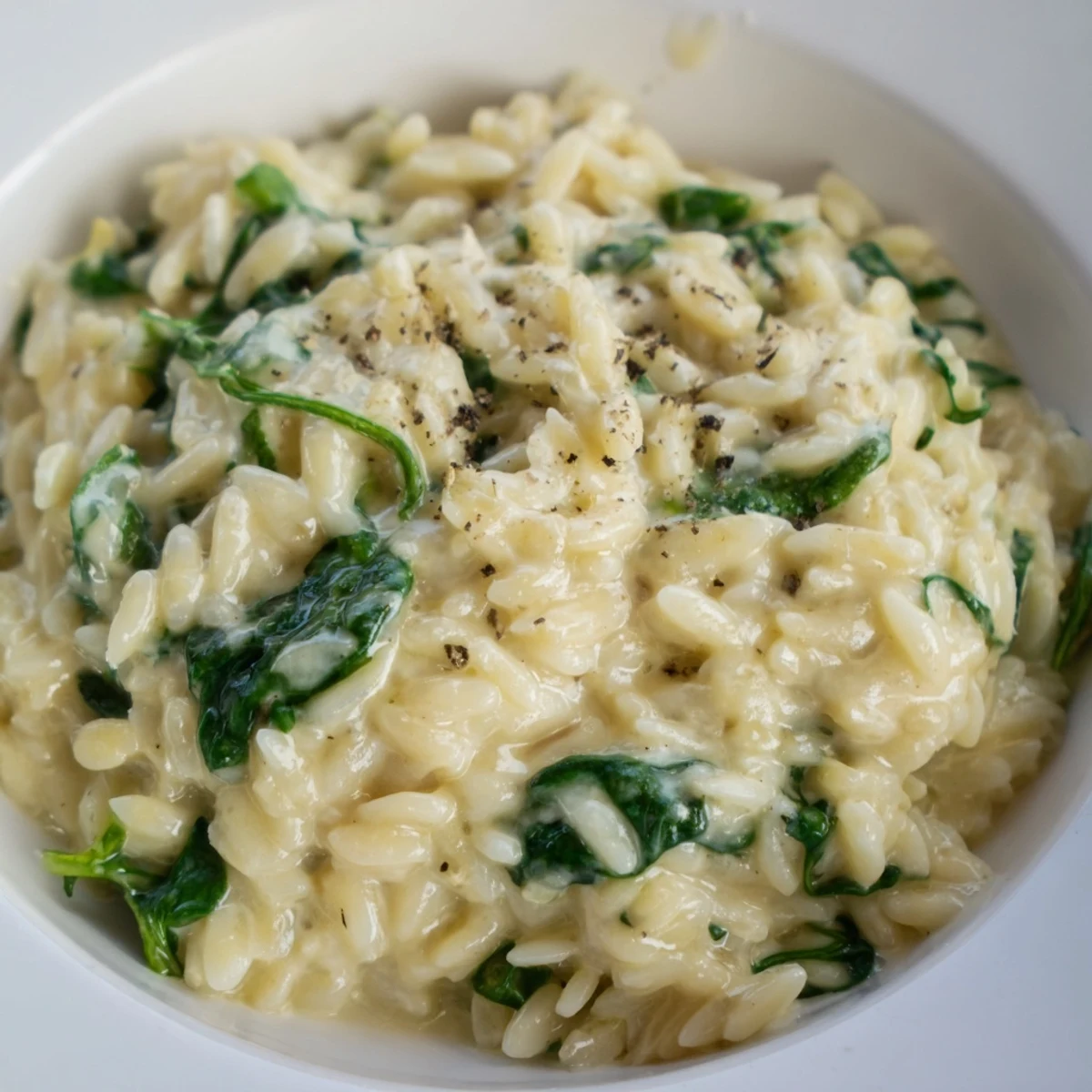 This Creamy Spinach Orzo showcases tender pasta swimming in a rich, creamy, and flavorful sauce.