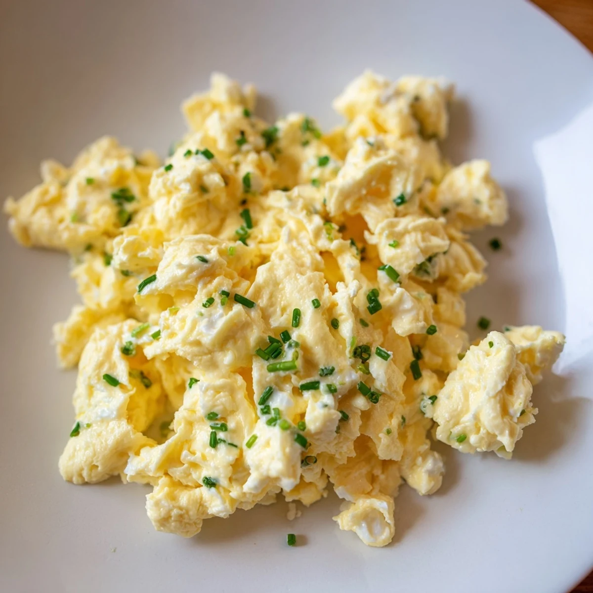 Golden-yellow cottage cheese scrambled eggs ready to serve, a quick and easy American breakfast recipe.