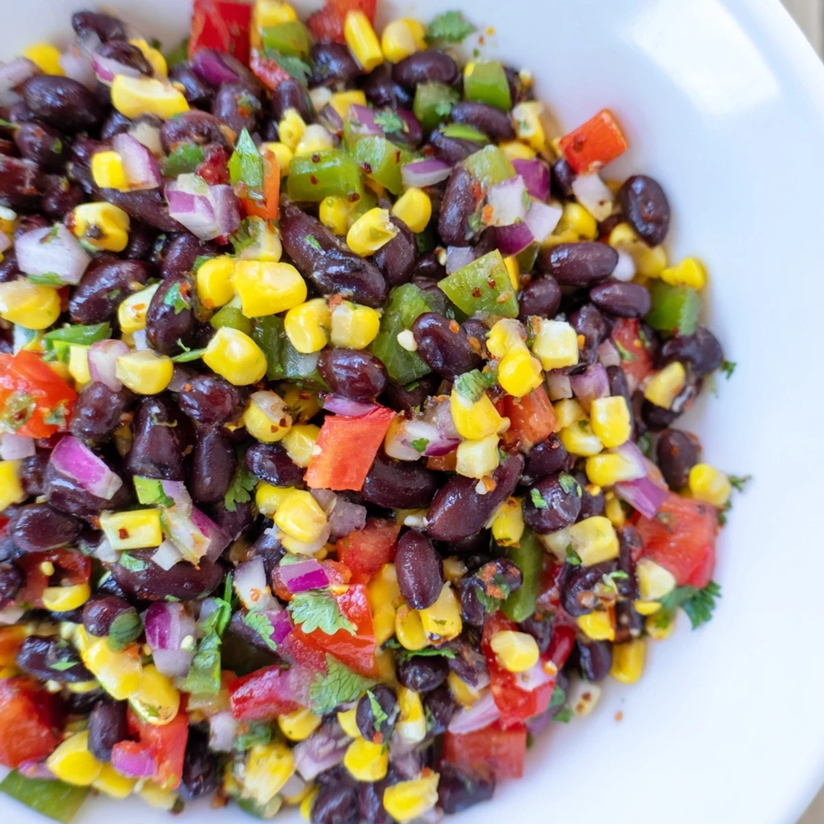 A refreshing bowl of Cowboy Caviar Salad offers a perfect balance of textures and delicious Southwestern flavors.