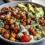 A vibrant grain bowl with roasted chickpeas, fresh veggies, and zesty lemon vinaigrette.  