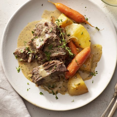 Succulent Slow Cooker Creamy Pot Roast with tender vegetables and rich herb sauce.  