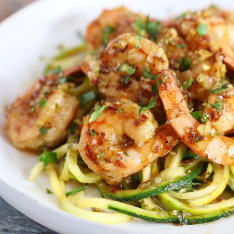 Succulent garlic butter shrimp over vibrant zucchini noodles, a delicious low-carb dish.  