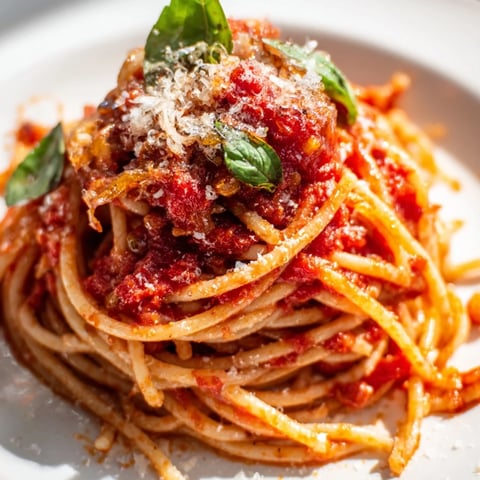 Classic spaghetti with marinara sauce topped with fresh basil and grated Parmesan.  