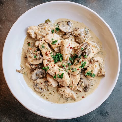 Creamy Chicken Stroganoff with tender chicken and mushrooms, served hot over a bed of fluffy noodles.