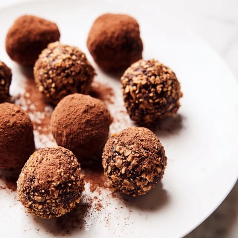 Delicious Date & Walnut Truffles, coated in cocoa, ready to enjoy as a sweet vegan treat.