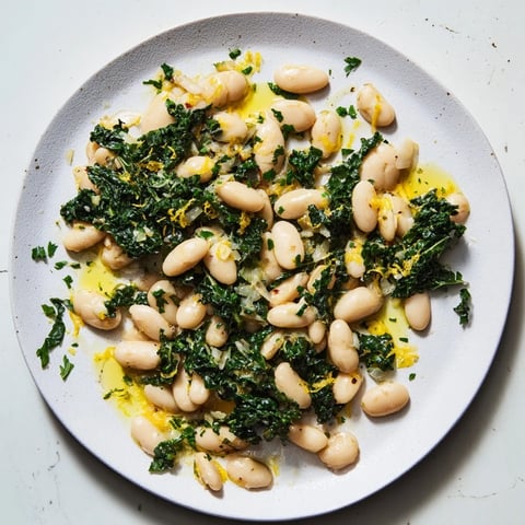 Garlicky beans with winter greens, a bright, inviting photo of this hearty, flavorful Mediterranean main dish.