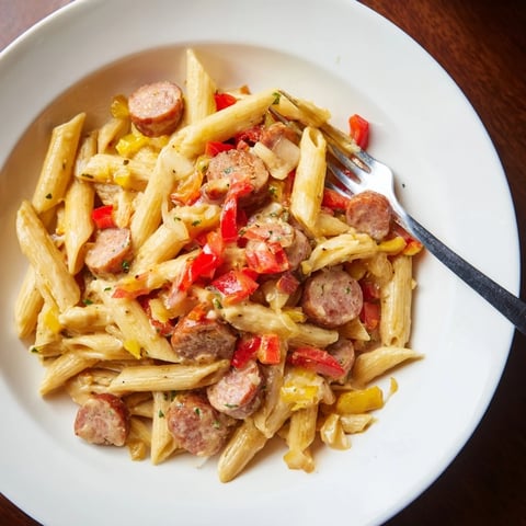 Golden, creamy Smoked Sausage Cajun Alfredo with penne, a comforting bowl of pasta topped with fresh parsley.