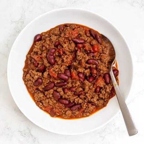 Slow cooker chili, a rich, hearty stew bubbling in its crock pot, ready for a delicious, easy dinner.