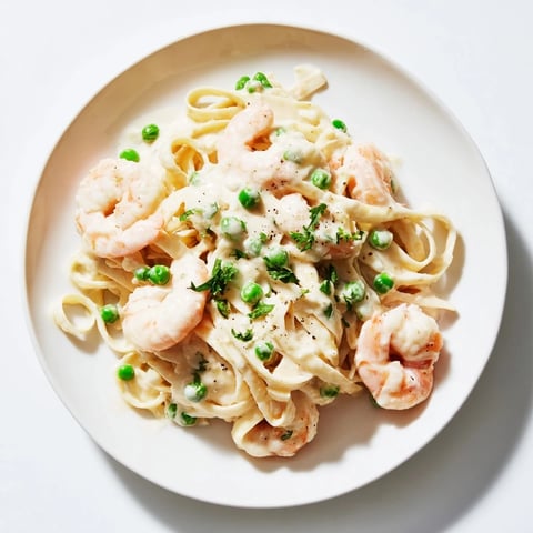 Steaming Instant Pot Shrimp Alfredo Pasta, a comforting weeknight meal with creamy sauce and shrimp.