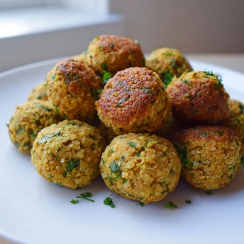 Golden-brown Levantine falafel balls, irresistibly crispy on the outside and flavorful inside, perfect for sharing.