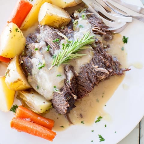 Aromatic Slow Cooker Creamy Pot Roast, simmered to perfection with hearty potatoes and carrots.  