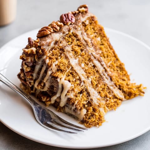 Warm and inviting pumpkin spice coffee cake served with a drizzle of maple glaze.  