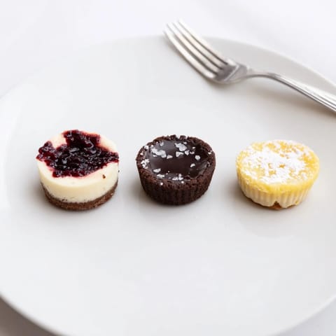 A close-up shot of the Mini Dessert Bites Trio, featuring tart chocolate ganache and zesty lemon filling.