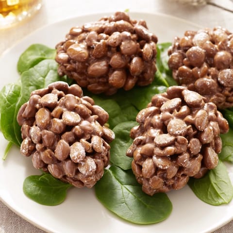 Looking at a plate of delicious Coco Pop chocolate pinecone dessert salad with fresh strawberries.
