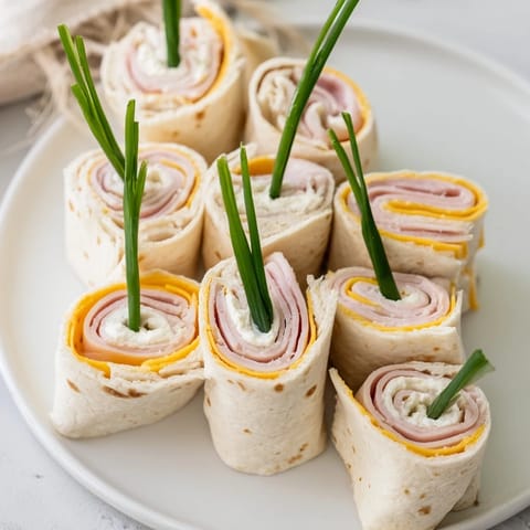 Delicious Graduation Cap Diploma Snack Wraps with mini chocolate caps and savory deli filling, perfect for celebrating.
