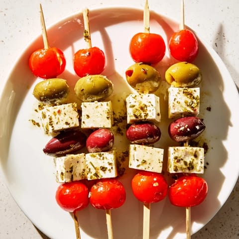 Picture the bright red tomatoes and green olives on Holiday Cheers Olive and Feta Skewers, ready for easy snacking.
