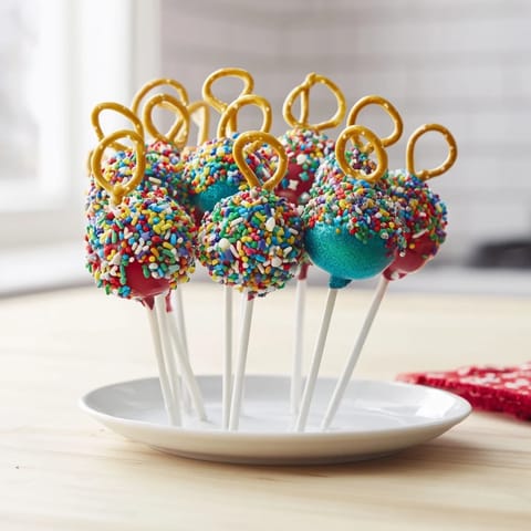 Mouthwatering close-up of colorful and glittery Ornament Ball Cake Pops, a sweet treat to enjoy.