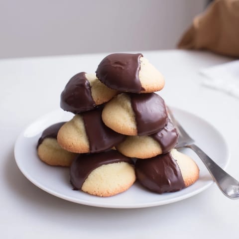 Crisp vanilla wafers, transformed into irresistible Simple Cookies, boasting a rich chocolate coating.
