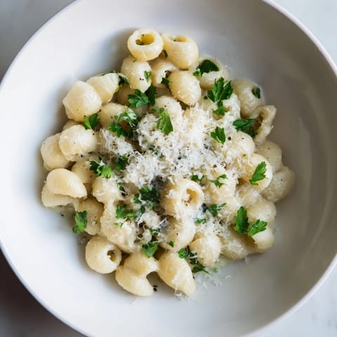 Close-up of vibrant 15-Minute Garlic Parmesan Pasta, showcasing perfectly cooked ditalini and Parmesan cheese.