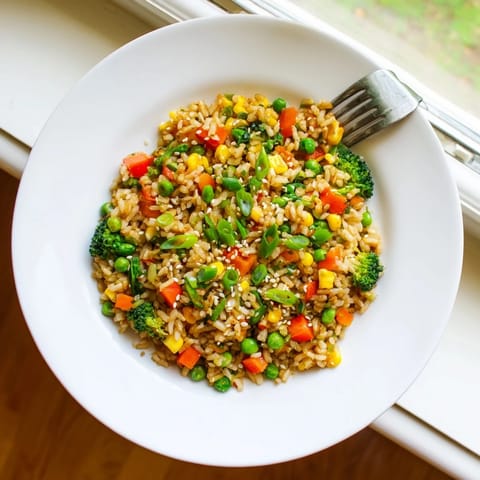 This easy Asian-inspired vegetable fried rice features fluffy grains, crisp broccoli, and a savory sesame sauce.  