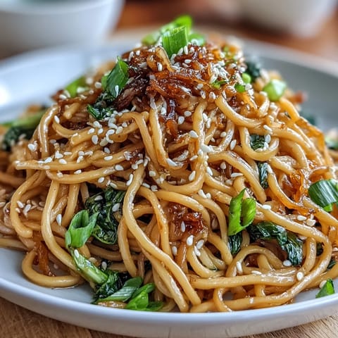 Silky wheat noodles coated in a fragrant ginger-scallion sauce, topped with crisp sautéed baby bok choy.  