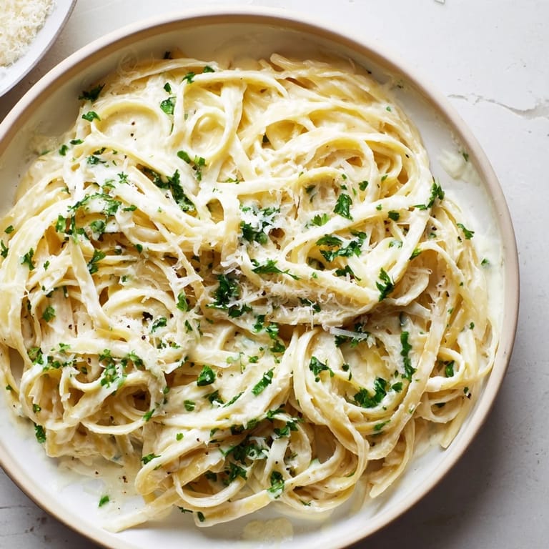 Tender fettuccine pasta coated in creamy, dreamy Creamy Greek Yogurt Spinach Alfredo, perfect for a cozy dinner.