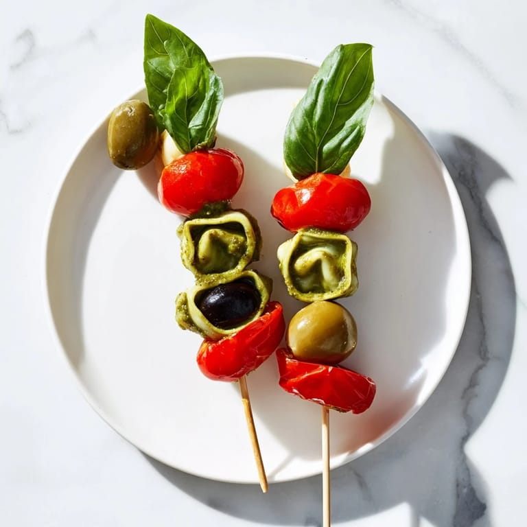 These vibrant Appetizer Skewers present a delightful mix of flavors with cheesy tortellini and fresh basil.