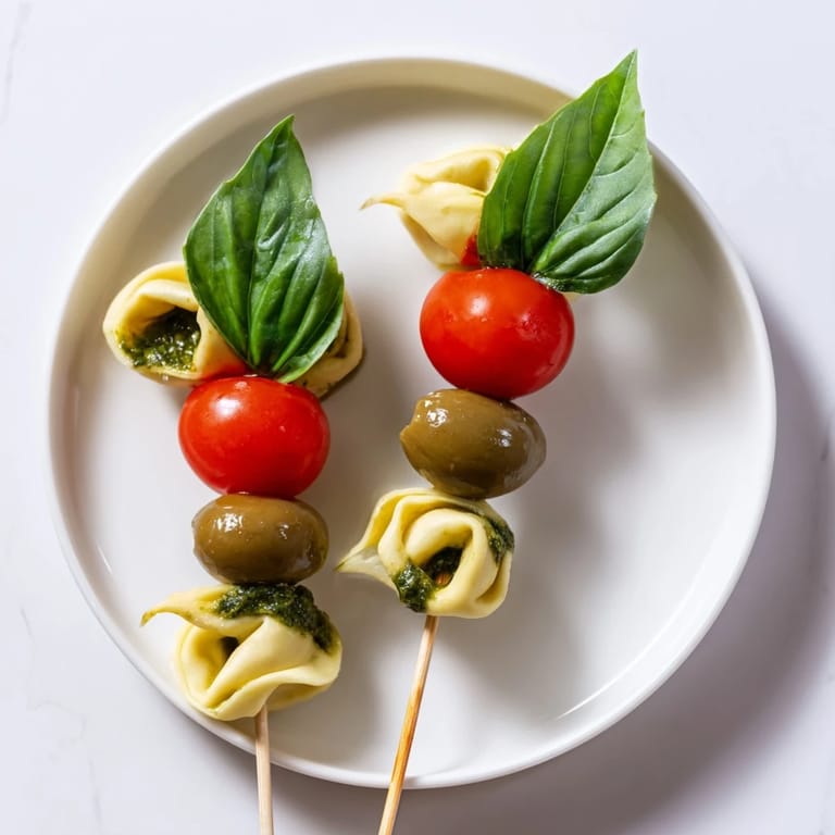 Enjoy these easy Appetizer Skewers, a medley of tortellini, olives, and pesto perfect for entertaining guests.