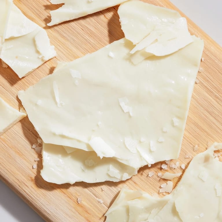 The Arctic Tundra dessert of white chocolate and cheese looks delectable, served on a rustic wooden board.