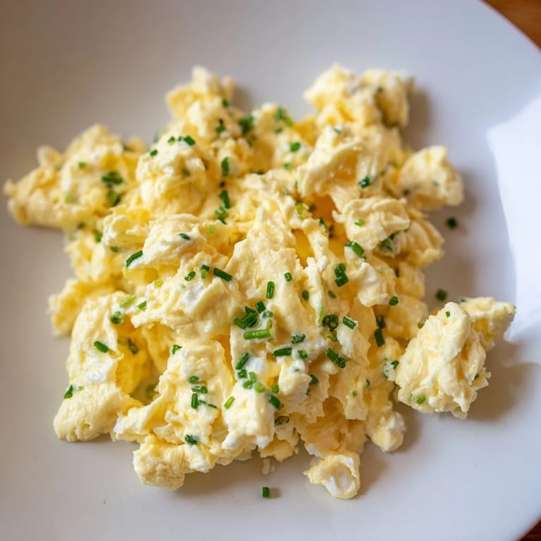 Golden-yellow cottage cheese scrambled eggs ready to serve, a quick and easy American breakfast recipe.