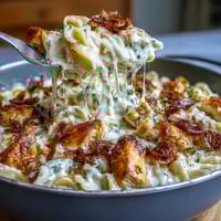 Creamy one-pot French onion chicken pasta with caramelized onions and melty Gruyère cheese in a cozy skillet meal.