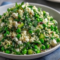 Fresh spring pea and mint couscous salad with vibrant green peas and herbs, perfect for Easter gatherings.  